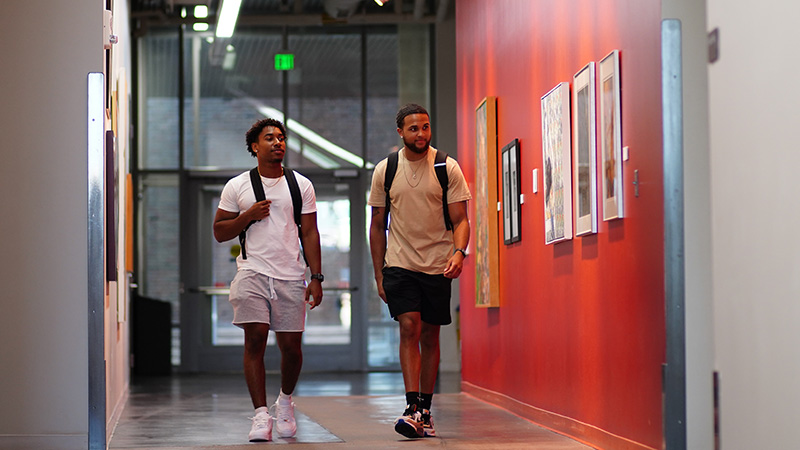 Two male students walking in Richmond Center
